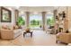 Inviting living room with large windows overlooking a pond and manicured lawn at 13 Buell Mansion Pkwy, Englewood, CO 80113