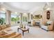 Elegant living room with neutral tones, fireplace, and views of the backyard fountain at 13 Buell Mansion Pkwy, Englewood, CO 80113