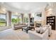 Elegant living room featuring a cozy fireplace, comfortable seating, and scenic outdoor views at 13 Buell Mansion Pkwy, Englewood, CO 80113