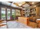Executive office with custom wood trim, built-in shelving, and outdoor access at 13 Buell Mansion Pkwy, Englewood, CO 80113
