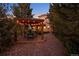 Beautiful backyard with a cozy pergola, outdoor seating and pathway to the house at dusk at 11541 Warrington Ct, Parker, CO 80138