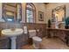 Charming powder room with pedestal sink, decorative mirror, and stylish accents throughout at 11541 Warrington Ct, Parker, CO 80138