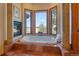 Luxurious bathroom features a soaking tub with fireplace and a large window with scenic views at 11541 Warrington Ct, Parker, CO 80138