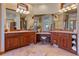 Elegant primary bathroom with double sinks, vanity area, and custom cabinets for ample storage at 11541 Warrington Ct, Parker, CO 80138