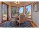 Bright dining area with a round table set, large windows, and hardwood floors at 11541 Warrington Ct, Parker, CO 80138
