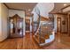 Grand foyer with a curved staircase, hardwood floors, and elegant details throughout the entrance at 11541 Warrington Ct, Parker, CO 80138
