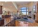 Open-concept living room with a fireplace, hardwood floors, and lots of natural light at 11541 Warrington Ct, Parker, CO 80138