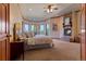Spacious main bedroom with a fireplace and a bay window with seating offering stunning views at 11541 Warrington Ct, Parker, CO 80138