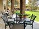 Covered patio with stone pillars and multiple seating areas overlooking the serene backyard with gazebo at 11541 Warrington Ct, Parker, CO 80138
