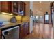 Elegant wet bar with custom cabinets, granite countertops, and a wine refrigerator at 11541 Warrington Ct, Parker, CO 80138