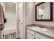 Clean bathroom featuring a single sink vanity with a mirror and a shower-tub combo at 7895 Allison Way # 203, Arvada, CO 80005