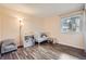 Neutral toned bedroom featuring hardwood floors, large window, and a crib at 7895 Allison Way # 203, Arvada, CO 80005