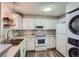 Well-lit kitchen with stainless steel sink, appliances, and ample cabinet space at 7895 Allison Way # 203, Arvada, CO 80005