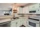 Bright kitchen with stainless steel sink, appliances, and open view of living area at 7895 Allison Way # 203, Arvada, CO 80005