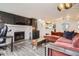 Inviting living room with fireplace, hardwood floors, and open concept kitchen at 7895 Allison Way # 203, Arvada, CO 80005