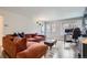 Cozy living room with a comfortable sectional sofa, hardwood floors, and a bright window at 7895 Allison Way # 203, Arvada, CO 80005