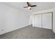 A carpeted bedroom with large closet and neutral colors at 3022 S Wheeling Way # 109, Aurora, CO 80014