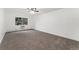 Spacious bedroom featuring neutral carpet, white walls, a ceiling fan, and a window for natural light at 3022 S Wheeling Way # 109, Aurora, CO 80014