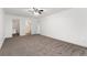 Bright bedroom boasts carpet, white walls, ceiling fan, and convenient access to the en-suite bathroom at 3022 S Wheeling Way # 109, Aurora, CO 80014