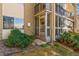 Exterior view of the entrance to a condo with a screened in porch and beautiful landscaping at 3022 S Wheeling Way # 109, Aurora, CO 80014