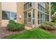 Exterior showing a building with enclosed lanai, landscaping and stone accents at 3022 S Wheeling Way # 109, Aurora, CO 80014