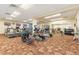 Well-equipped gym with treadmills, ellipticals, weights, and mirrored walls for a complete workout experience at 3022 S Wheeling Way # 109, Aurora, CO 80014