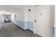Hallway featuring patterned carpet, light sconce, and view of entrance at 3022 S Wheeling Way # 109, Aurora, CO 80014