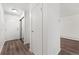 Clean, well-lit hallway with wood-look floors, white walls, and convenient access to various rooms at 3022 S Wheeling Way # 109, Aurora, CO 80014