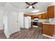 Cozy kitchen with wood cabinets, white appliances, and neutral countertops providing a functional cooking space at 3022 S Wheeling Way # 109, Aurora, CO 80014