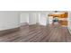 Open-concept living area featuring wood-look floors, white walls, and seamless transition to the kitchen and other spaces at 3022 S Wheeling Way # 109, Aurora, CO 80014