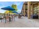 Inviting outdoor patio with comfortable seating, umbrellas, and views of the surrounding landscape at 3022 S Wheeling Way # 109, Aurora, CO 80014