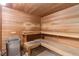 Relaxing sauna room featuring wood paneling, bench seating, and a heating unit for a therapeutic experience at 3022 S Wheeling Way # 109, Aurora, CO 80014