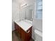 Bathroom with double vanity and wood-look flooring at 25643 E Bayaud Ave, Aurora, CO 80018