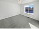 Bright bedroom with large window and grey carpet at 25643 E Bayaud Ave, Aurora, CO 80018