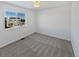 Bright bedroom with a large window and grey carpet at 25643 E Bayaud Ave, Aurora, CO 80018