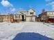 Two-story house with snow-covered yard, attached garage, and neutral color scheme at 25643 E Bayaud Ave, Aurora, CO 80018
