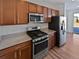 Modern kitchen with granite countertops and gas range at 25643 E Bayaud Ave, Aurora, CO 80018