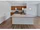Kitchen with island, light cabinets, and stainless steel appliances at 25643 E Bayaud Ave, Aurora, CO 80018
