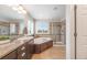 Bathroom featuring a vanity, bathtub, and glass enclosed shower at 673 Tiger Lily Way, Highlands Ranch, CO 80126