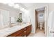 Bathroom with double sinks, a large mirror, and a shower at 673 Tiger Lily Way, Highlands Ranch, CO 80126