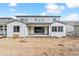 Backyard featuring a white two-story house with a patio, sliding glass doors, and a large dirt lot at 2536 Wesley Ln, Lafayette, CO 80026