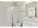 Bathroom with a walk-in shower with a glass door, a modern sink and large mirror at 2536 Wesley Ln, Lafayette, CO 80026