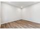 An empty bedroom is well lit, has wood floors and neutral paint at 2536 Wesley Ln, Lafayette, CO 80026
