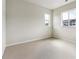 Bedroom featuring neutral carpet, paint and two windows at 2536 Wesley Ln, Lafayette, CO 80026