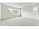 Large bedroom with neutral carpet and walls with three windows for natural light at 2536 Wesley Ln, Lafayette, CO 80026