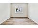 Empty bedroom with hardwood floors, neutral paint, a window, and base trim at 2536 Wesley Ln, Lafayette, CO 80026