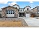 Beautiful home with stone accents, a well-manicured lawn, and a modern driveway at 2536 Wesley Ln, Lafayette, CO 80026