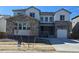 Attractive two-story home featuring a stone and siding exterior, complemented by a well-manicured lawn at 2536 Wesley Ln, Lafayette, CO 80026