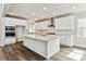 Bright, modern kitchen with stainless steel appliances and an island with white counter tops at 2536 Wesley Ln, Lafayette, CO 80026