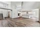 Open concept kitchen with white cabinetry, a center island and hardwood floors at 2536 Wesley Ln, Lafayette, CO 80026